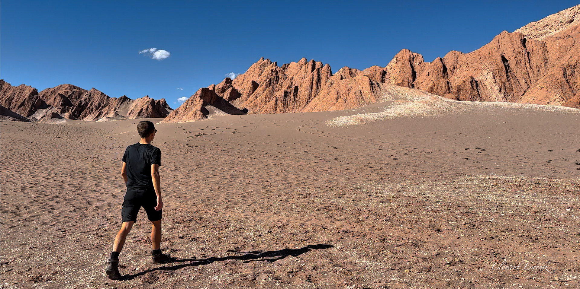 Valle de la Muerte San Perdo de Atacama Clement Lorentz is walking on the death valley or Valle de Marte at San Pedro de Atacama. Rocks, sand and blue sky.