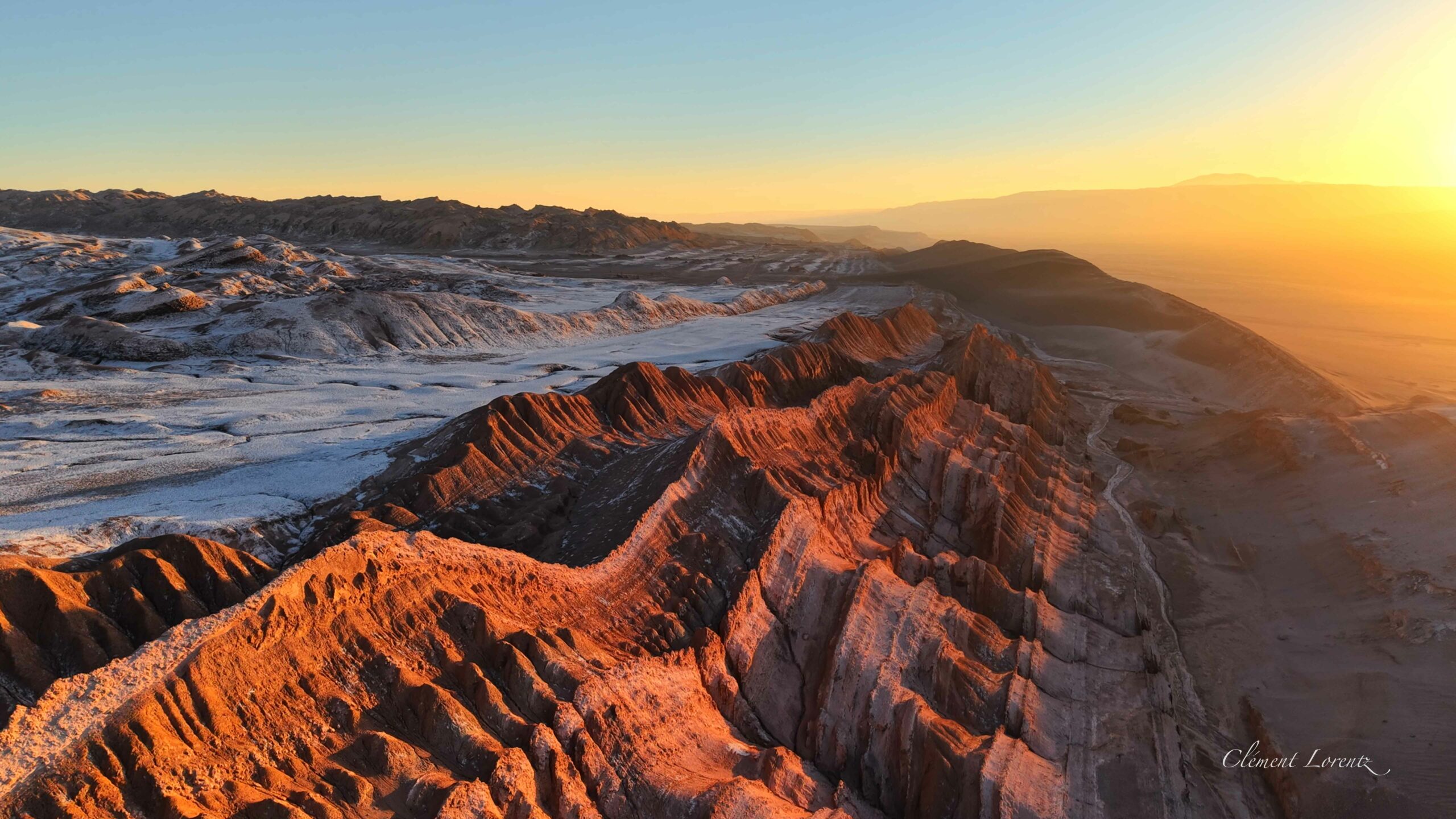 Cordillera de la Sal San Pedro Atacama 2 Salt mountains of the Cordillera de la Sal glowing orange at sunset with white salt formations.