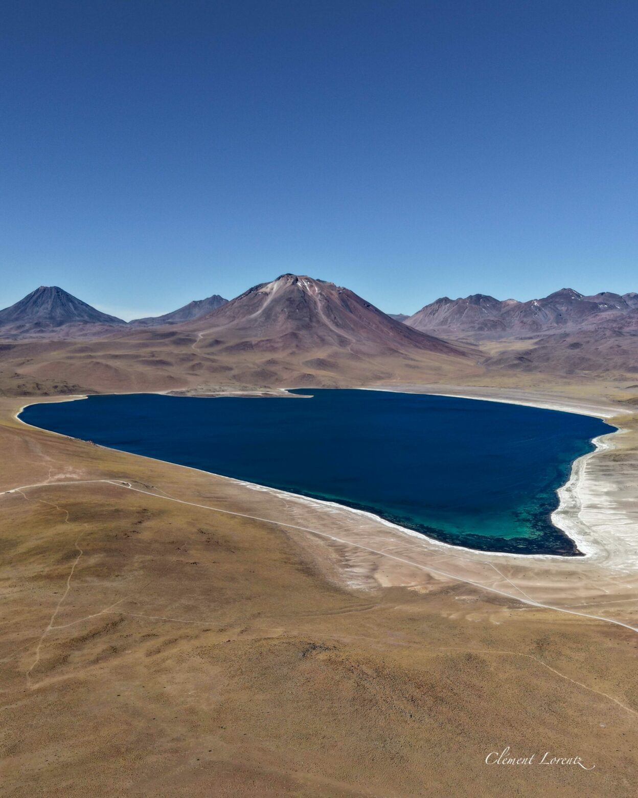 Lagunas Altiplanicas Atacama This aerial view shows the altiplanicas lagunes in the Atacama Desert. Blue water surrounded by volcans.