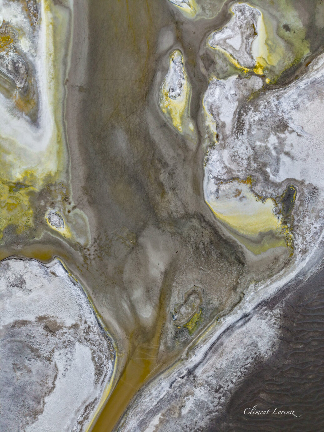 Altiplano Chile Abstract drone shot of a lagune in the altiplano of Chile. We can see colors like yellow, grey, withe and flamencos.