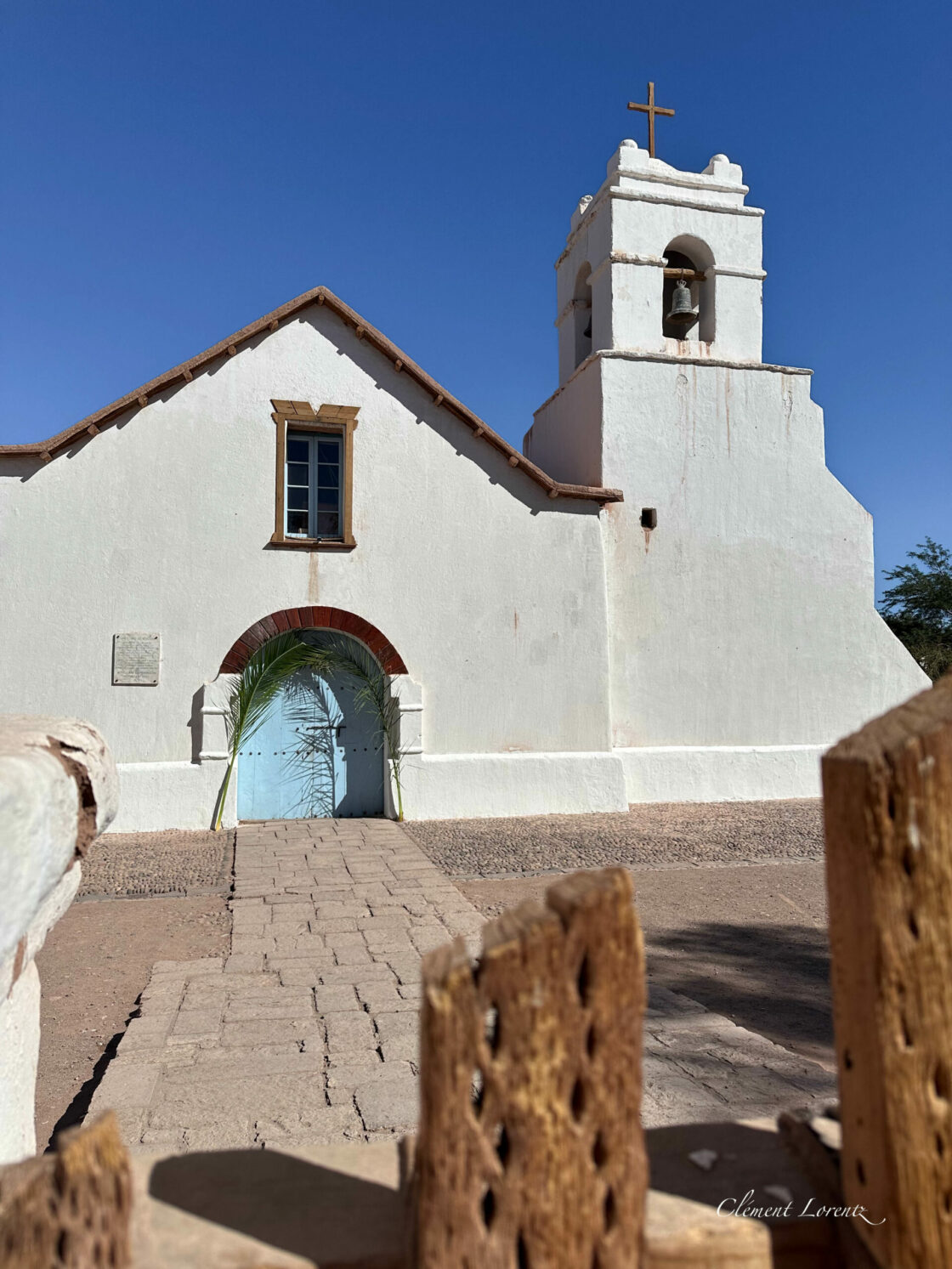 Eglise San Pedro Atacama Front cactus gate in soft focus leading to San Pedro de Atacama church in daylight.
