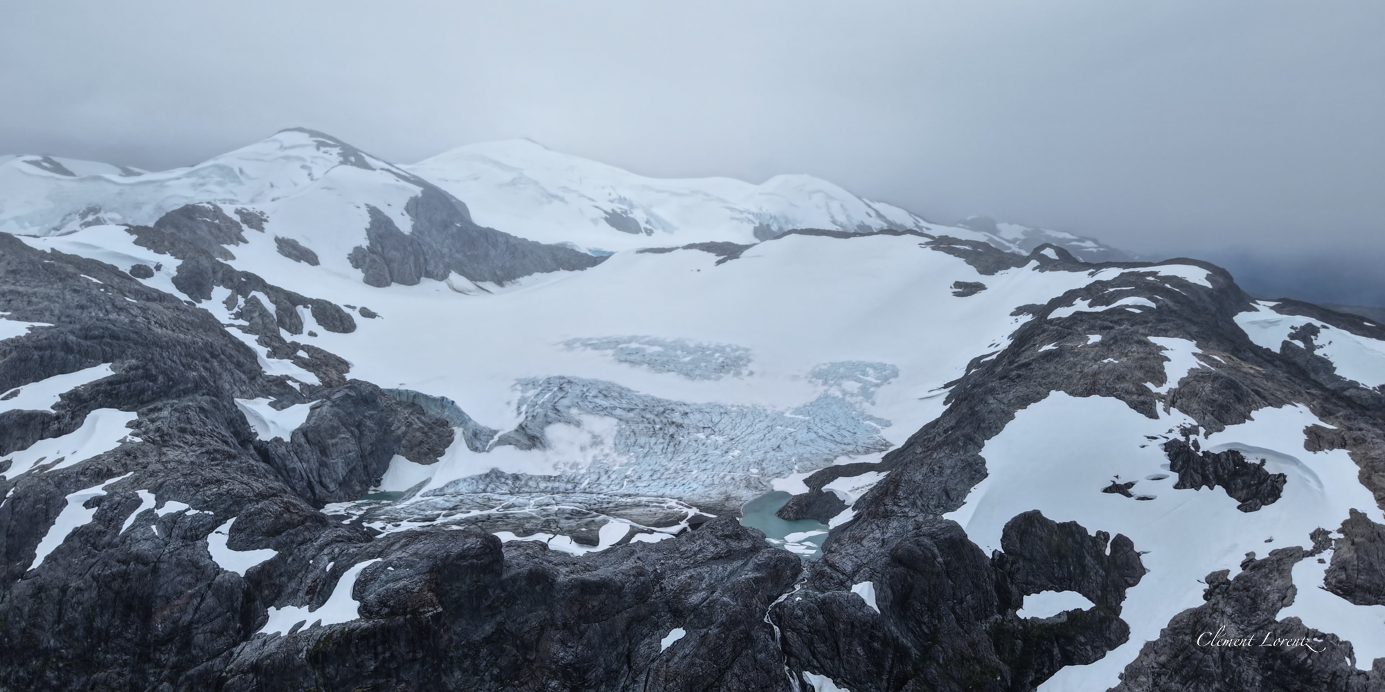 Glacier Carretera Austral Glacier beneath a thick layer of clouds along the Carretera Austral in Patagonia, Chile, captured in moody tones resembling black and white.