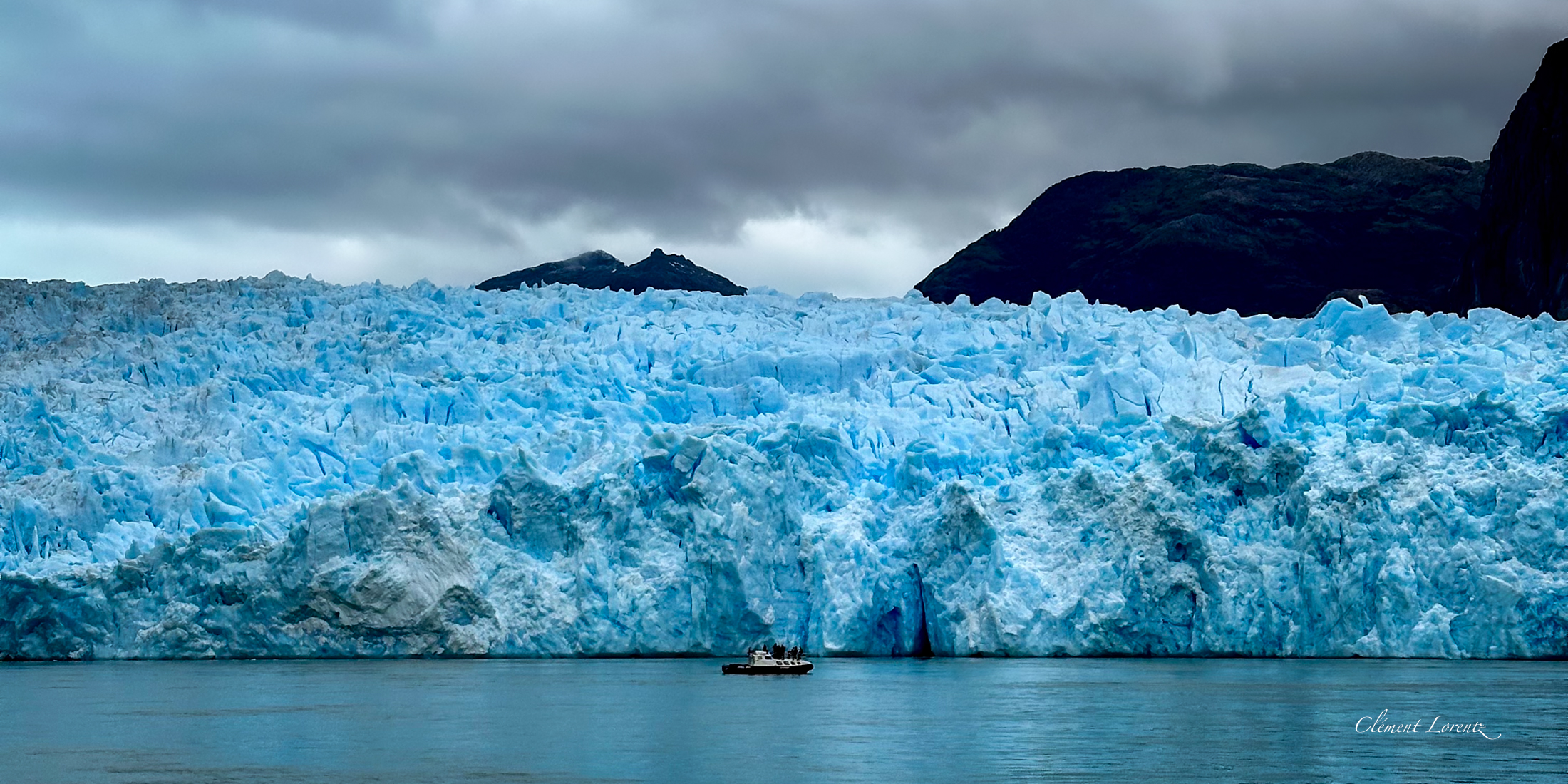 Glacier San Rafael Panoramic view of San Rafael Glacier in Patagonia, Chile, with a small boat at its base highlighting the glacier’s immense scale.