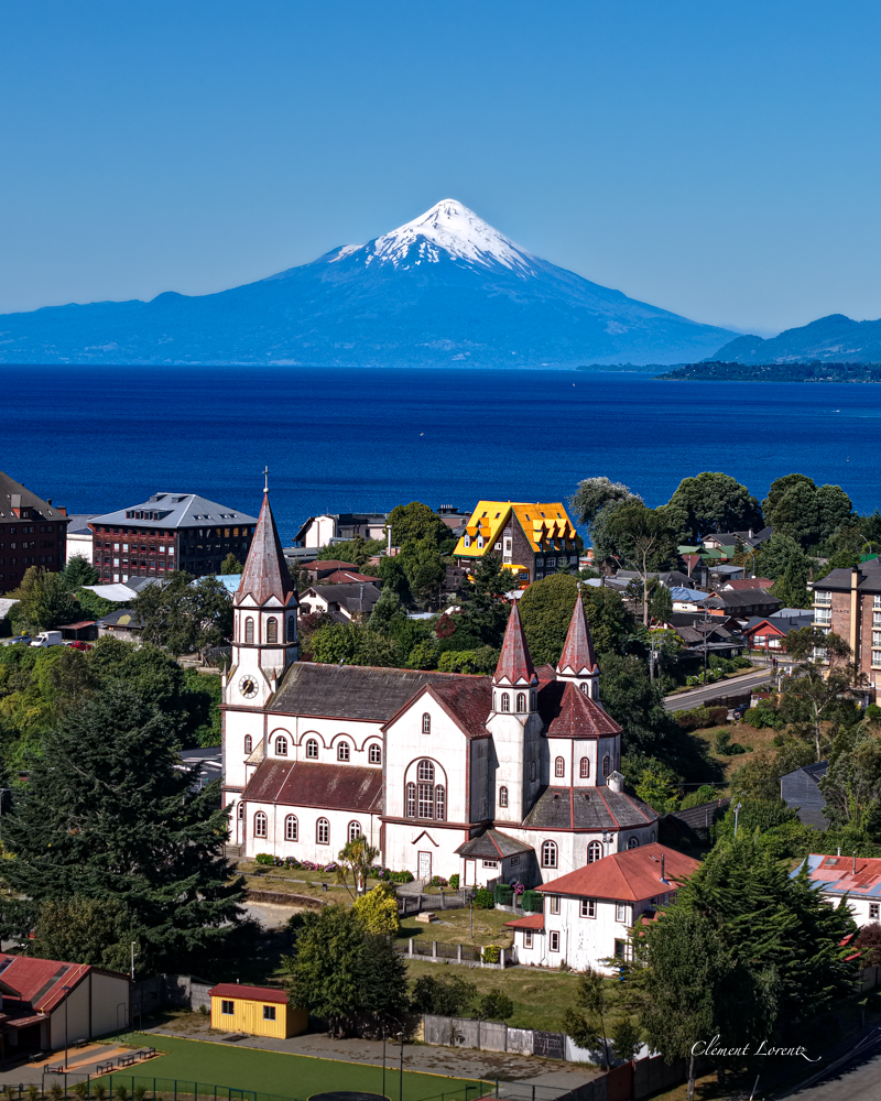 Puerto Varas Osorno Scenic view of Puerto Varas, Chile, featuring the Iglesia del Sagrado Corazón de Jesús in the foreground and the snow-capped Osorno Volcano in the background