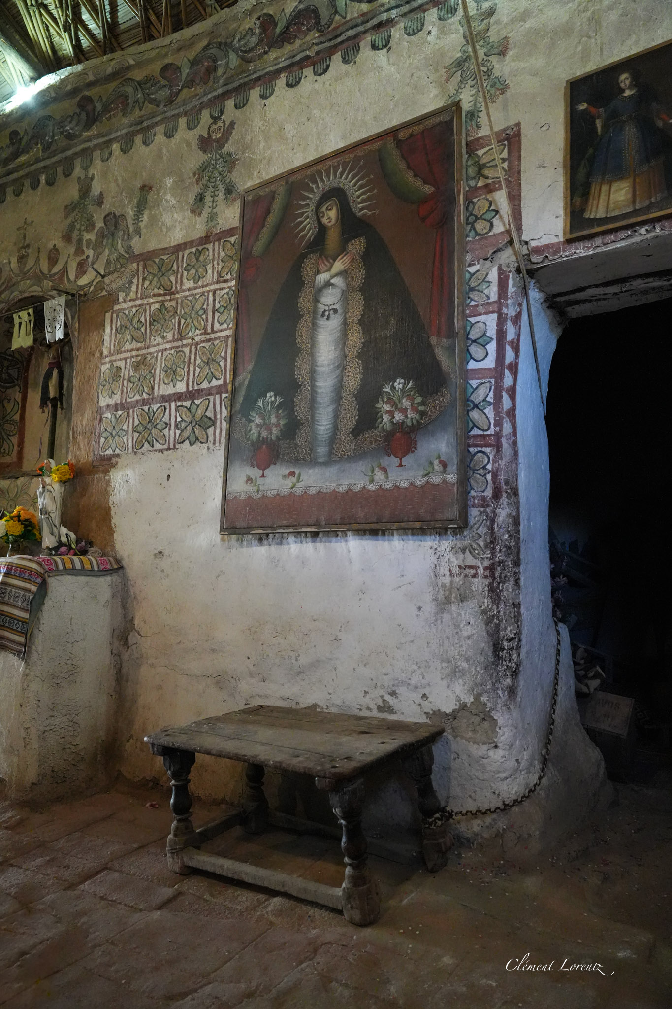 Colonial mural and wooden altar table inside Parinacota Church